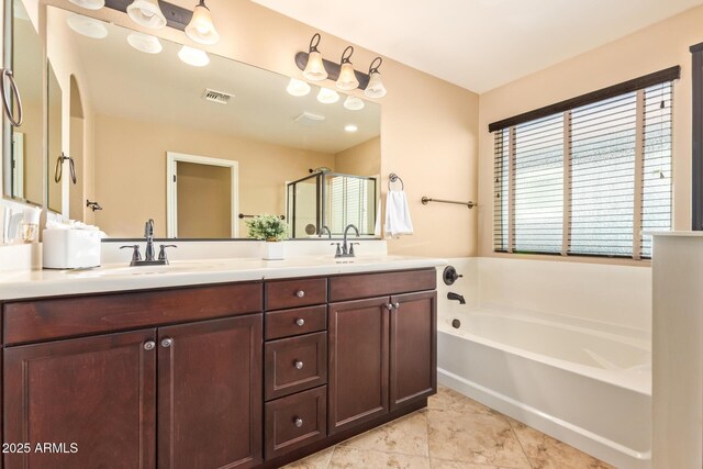 3443 E Jasper Dr, Gilbert, AZ 85296 - full bathroom featuring a garden tub, double vanity, and a shower stall