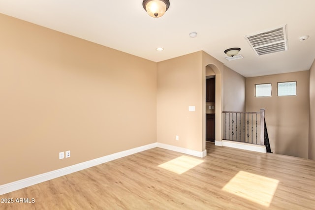 3443 E Jasper Dr, Gilbert, AZ 85296 - unfurnished room featuring light wood-style flooring, arched walkways, baseboards, a smoke detector, and recessed lighting