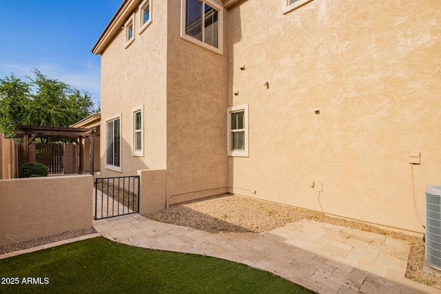 3443 E Jasper Dr, Gilbert, AZ 85296 - view of home's exterior with stucco siding, a pergola, a gate, and fence