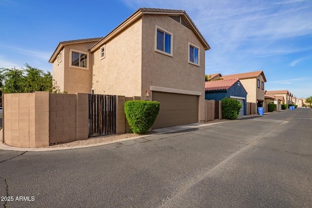 3443 E Jasper Dr, Gilbert, AZ 85296 - view of home's exterior with stucco siding, fence, an attached garage, and a residential view