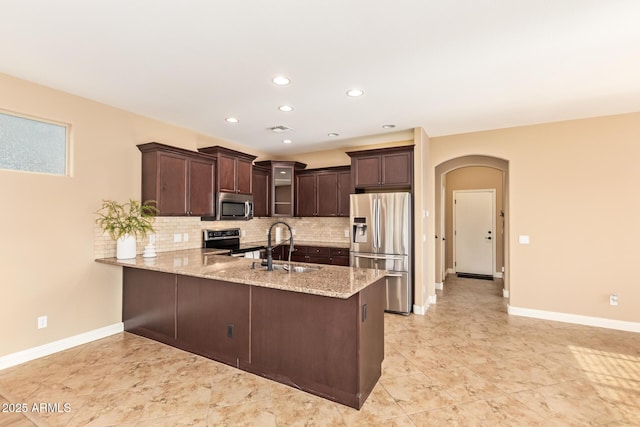 3443 E Jasper Dr, Gilbert, AZ 85296 - kitchen with appliances with stainless steel finishes, a sink, a peninsula, dark brown cabinets, and backsplash