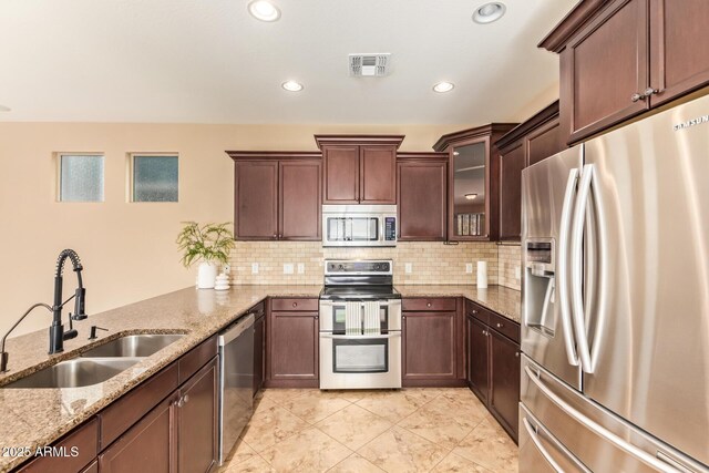 3443 E Jasper Dr, Gilbert, AZ 85296 - kitchen featuring appliances with stainless steel finishes, a sink, light stone countertops, tasteful backsplash, and recessed lighting