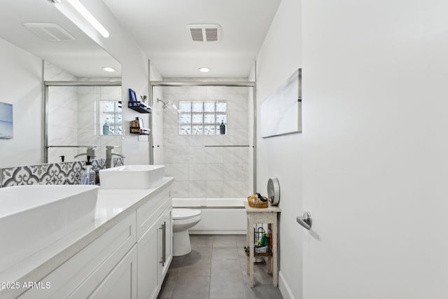 2129 W Indianola Ave, Phoenix, AZ 85015 - full bath with toilet, tile patterned flooring, enclosed tub / shower combo, double vanity, and recessed lighting