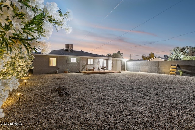 2129 W Indianola Ave, Phoenix, AZ 85015 - back of property at dusk with fence, cooling unit, and brick siding