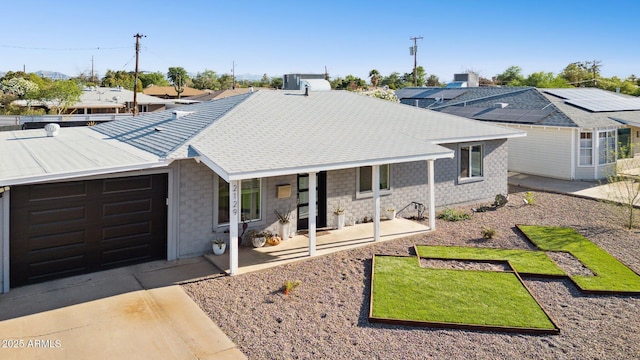 2129 W Indianola Ave, Phoenix, AZ 85015 - ranch-style house with covered porch, a garage, stone siding, and concrete driveway