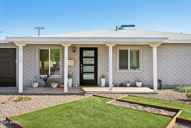 2129 W Indianola Ave, Phoenix, AZ 85015 - view of exterior entry with covered porch and a lawn