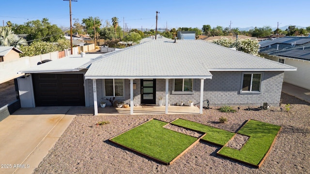 2129 W Indianola Ave, Phoenix, AZ 85015 - single story home with a porch, concrete driveway, a garage, and stone siding
