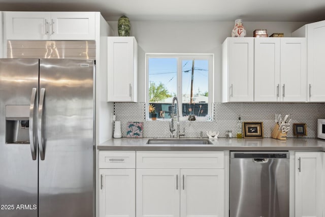 2129 W Indianola Ave, Phoenix, AZ 85015 - kitchen with stainless steel appliances, a sink, white cabinets, and decorative backsplash