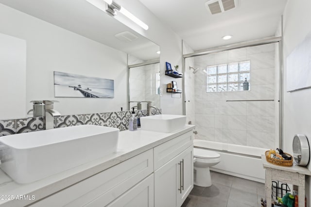 2129 W Indianola Ave, Phoenix, AZ 85015 - full bath with toilet, tile patterned floors, double vanity, enclosed tub / shower combo, and recessed lighting