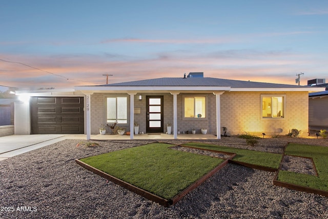 2129 W Indianola Ave, Phoenix, AZ 85015 - ranch-style house featuring concrete driveway, covered porch, an attached garage, and a front lawn