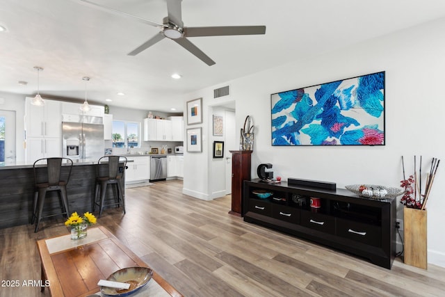 2129 W Indianola Ave, Phoenix, AZ 85015 - living room featuring a ceiling fan, light wood finished floors, recessed lighting, and baseboards