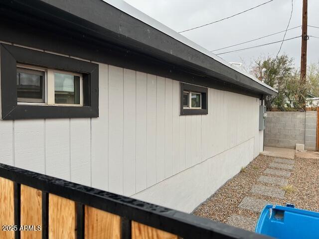 view of home's exterior with fence