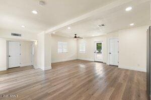 3021 N Randolph Rd, Phoenix, AZ 85014 - interior space with beam ceiling, a healthy amount of sunlight, and wood finished floors