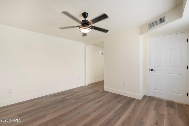 3021 N Randolph Rd, Phoenix, AZ 85014 - unfurnished room featuring wood finished floors, a ceiling fan, visible vents, and baseboards