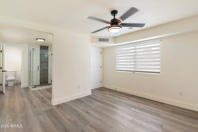 3021 N Randolph Rd, Phoenix, AZ 85014 - unfurnished bedroom with visible vents, a ceiling fan, ensuite bath, wood finished floors, and baseboards