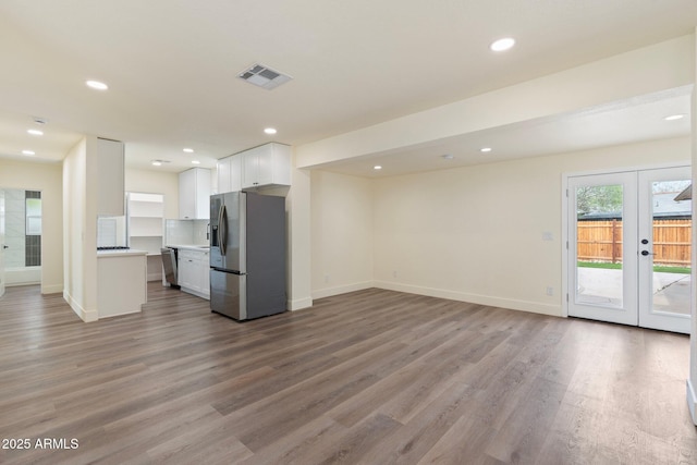 3021 N Randolph Rd, Phoenix, AZ 85014 - kitchen with visible vents, light countertops, appliances with stainless steel finishes, white cabinetry, and open floor plan