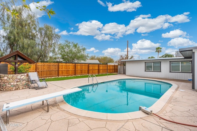 3021 N Randolph Rd, Phoenix, AZ 85014 - view of swimming pool with a diving board, a patio area, a fenced in pool, and a fenced backyard