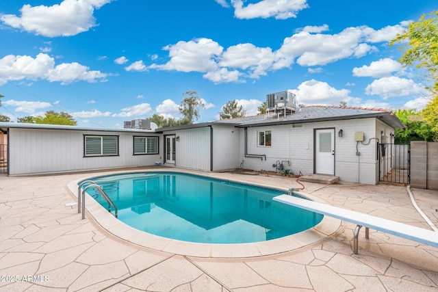 3021 N Randolph Rd, Phoenix, AZ 85014 - back of house with a patio, a gate, a fenced in pool, and brick siding