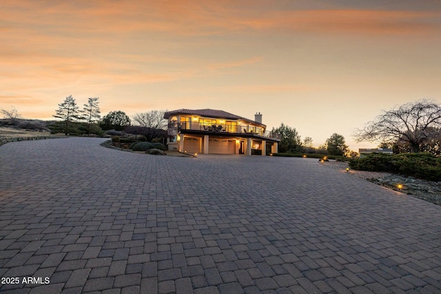 view of front of home with decorative driveway