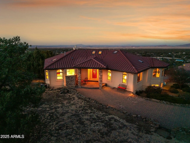 view of front of home with stucco siding and a tiled roof