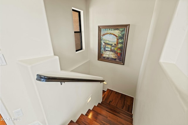 stairway featuring wood finished floors