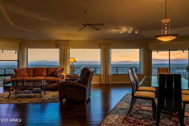 interior space featuring baseboards, dark wood-style flooring, and ceiling fan