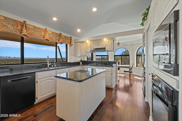 kitchen featuring a kitchen island, under cabinet range hood, a peninsula, black appliances, and a sink