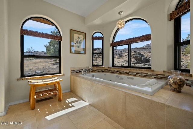 full bathroom with tile patterned floors, a healthy amount of sunlight, baseboards, and a tub with jets