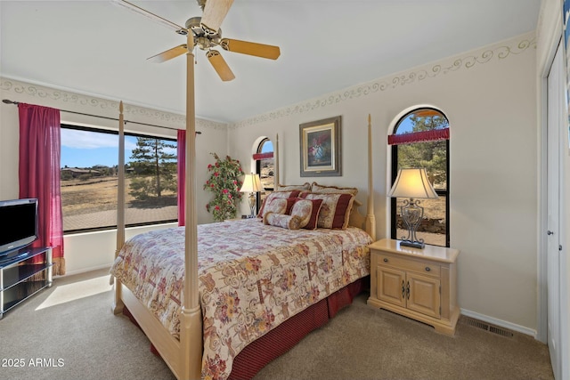 carpeted bedroom featuring a ceiling fan, baseboards, and visible vents