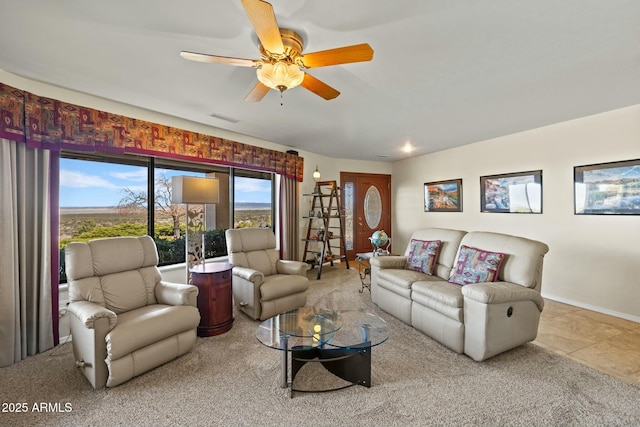 living room with visible vents, baseboards, a ceiling fan, and tile patterned flooring