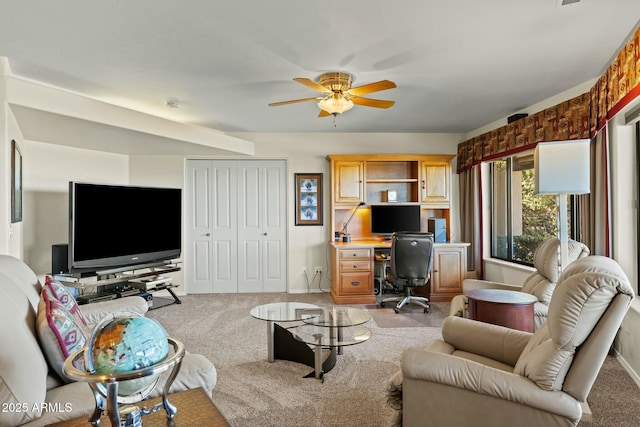 living room with a ceiling fan and light colored carpet