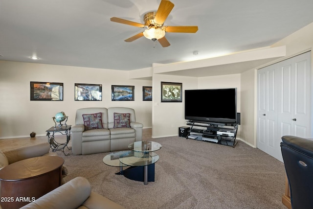 carpeted living area featuring baseboards and a ceiling fan