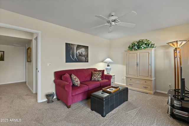 carpeted living room featuring baseboards and a ceiling fan