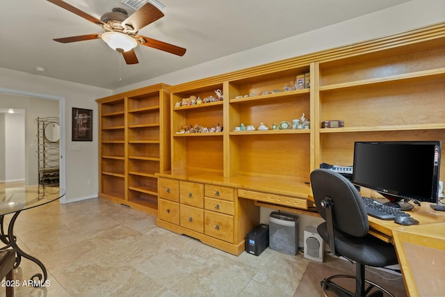 home office with ceiling fan, baseboards, and built in study area