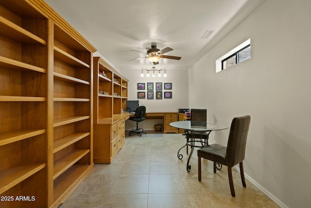 office space with light tile patterned floors, a ceiling fan, visible vents, baseboards, and built in desk