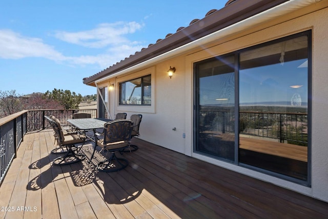 wooden terrace with outdoor dining area