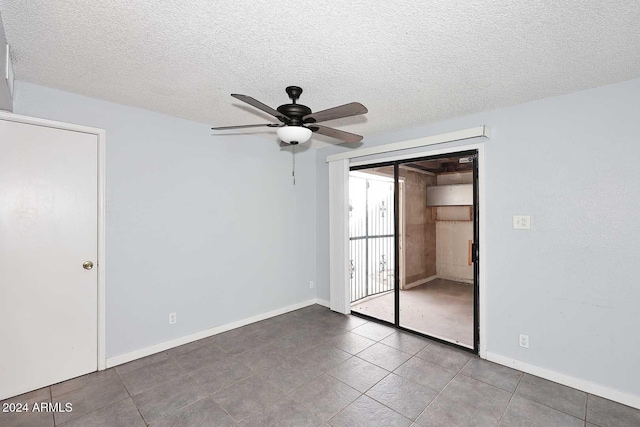 unfurnished bedroom featuring tile patterned flooring, a textured ceiling, a closet, and ceiling fan