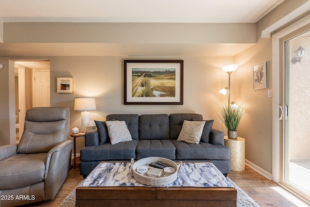 living area featuring light wood-style flooring and baseboards