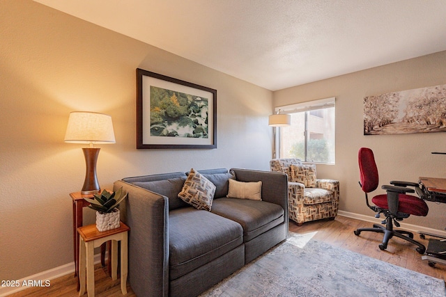 office space with baseboards and wood finished floors