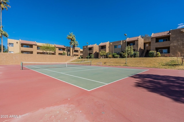 view of tennis court featuring a residential view and community basketball court