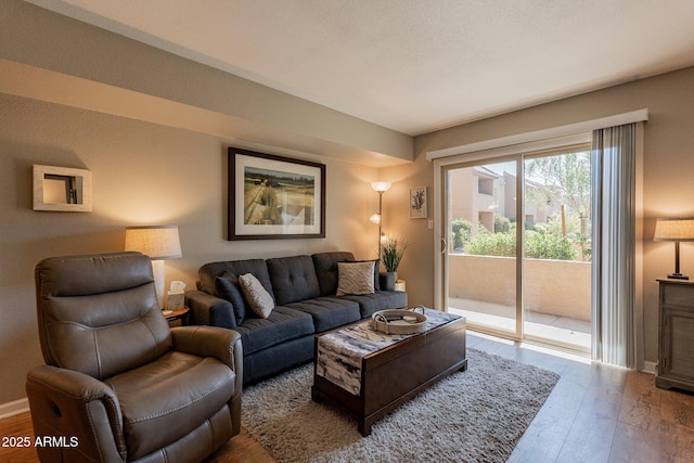 living area featuring baseboards and hardwood / wood-style floors