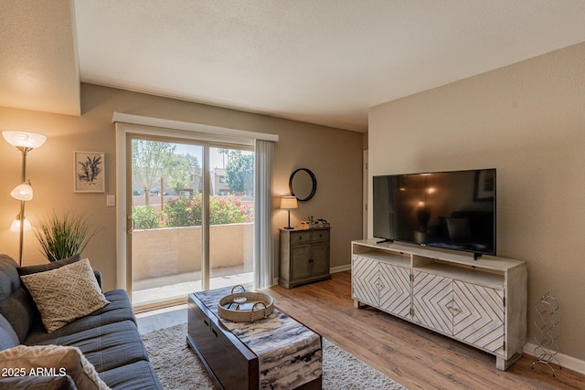 living area with wood finished floors and baseboards