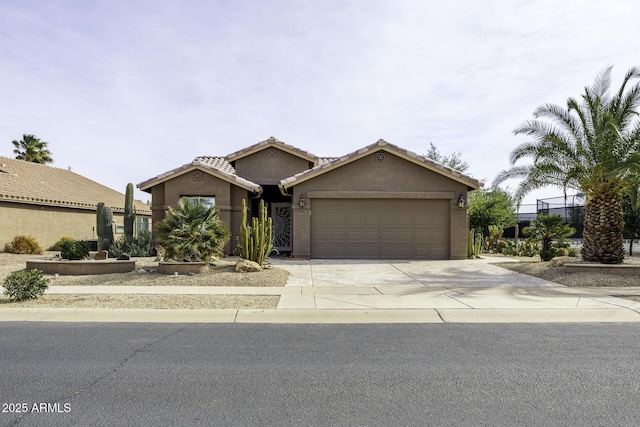 ranch-style house with a garage, driveway, stucco siding, and a tile roof
