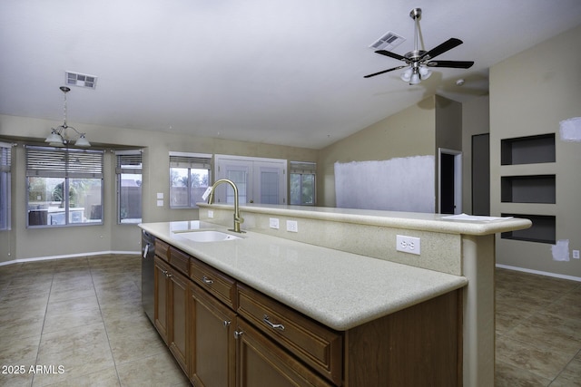 kitchen with vaulted ceiling, light tile patterned flooring, visible vents, dishwasher, and a sink