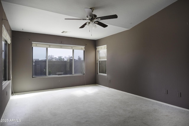 spare room featuring a ceiling fan, baseboards, carpet, and visible vents