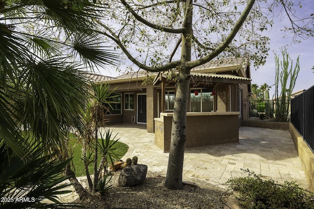 back of property with a patio area, a fenced backyard, and stucco siding