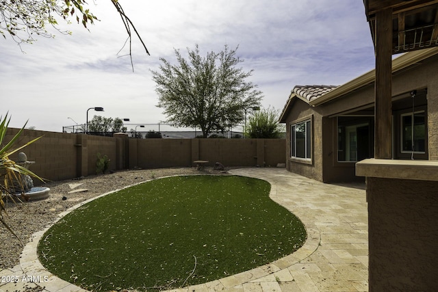 view of yard featuring a patio and a fenced backyard