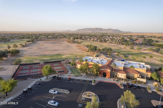 drone / aerial view with a mountain view and view of golf course