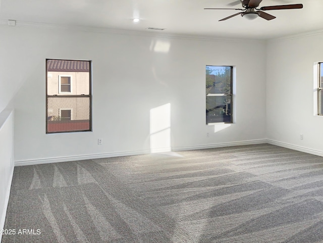 unfurnished room with carpet, ceiling fan, and crown molding