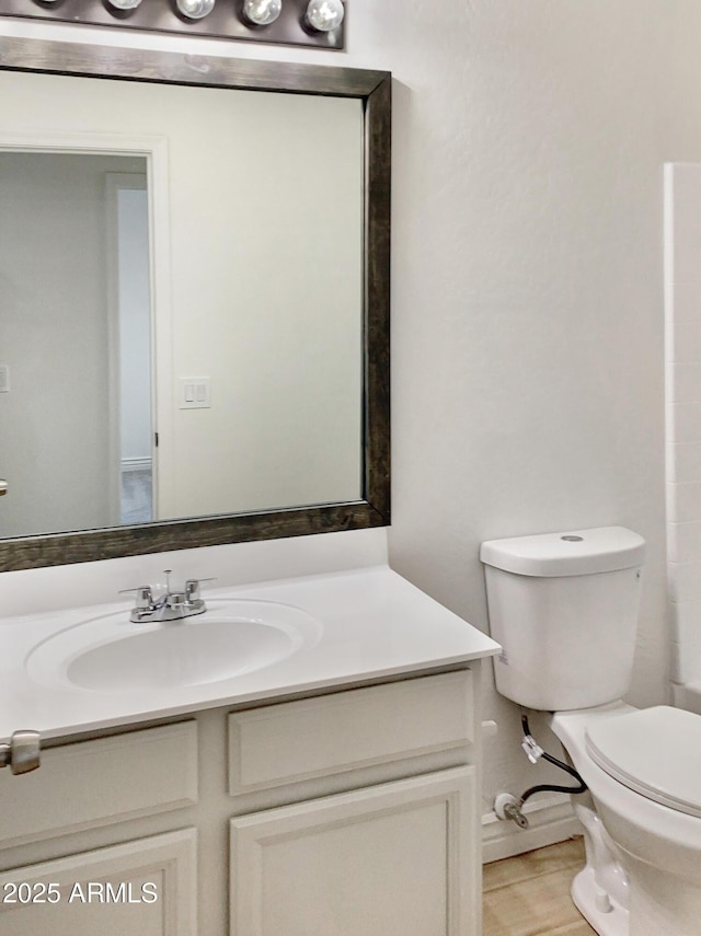 bathroom featuring vanity, toilet, and walk in shower